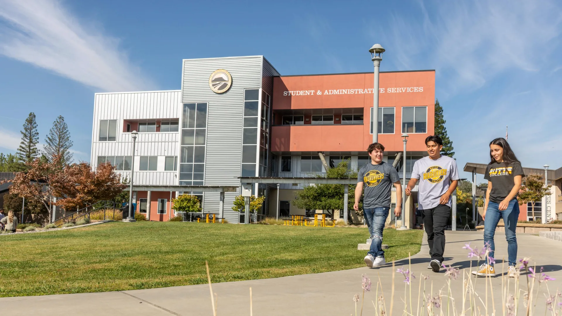 Three Butte College Students walk along campus