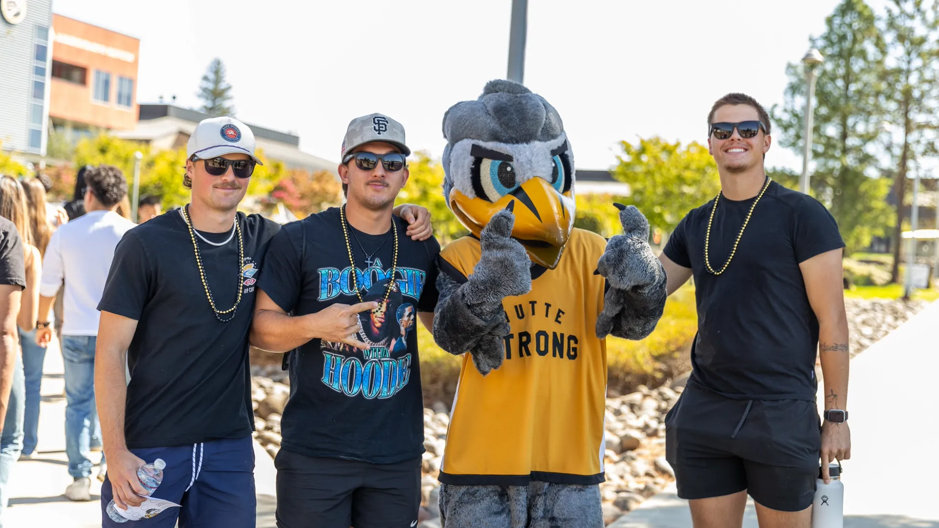 Three Butte College Students pose with Dash mascot
