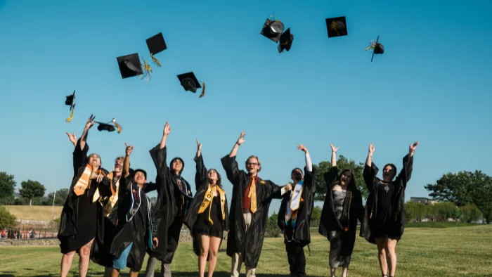 Butte College Graduates throw their graduation caps in the air