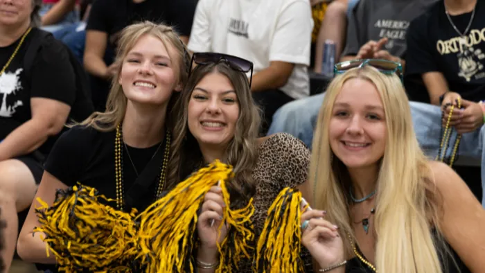 Butte College Roadrunner rush three friends cheer together at roadrunner rush