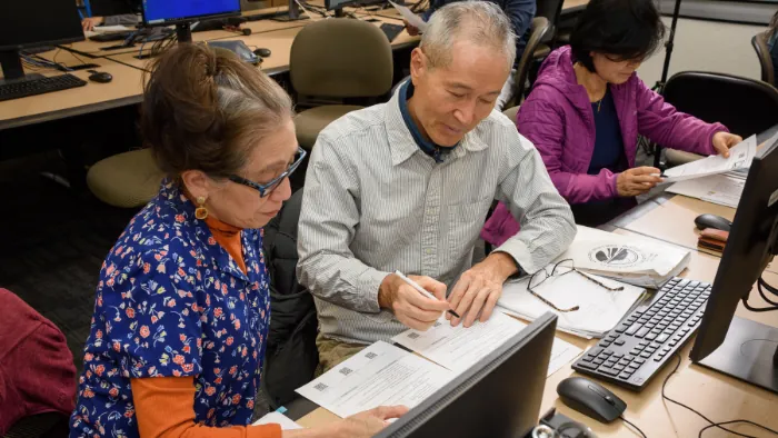 Three Butte College adult language learners complete their work