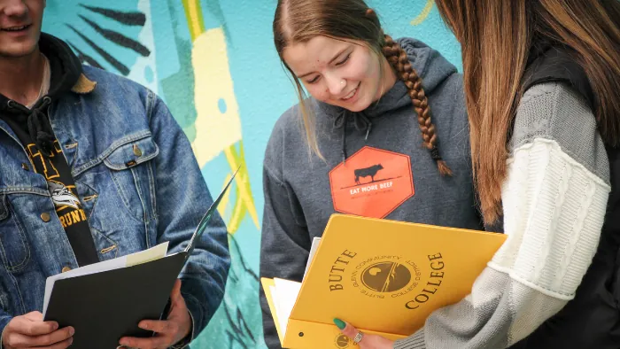 Butte College students review a notebook together