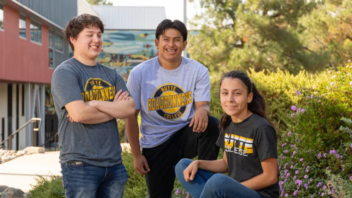 Three Butte College Students gather on campus in butte college t shirts