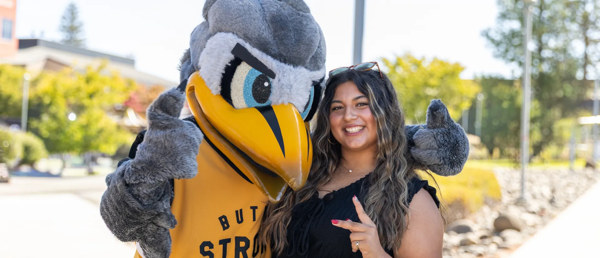 Butte College Student poses with Dash Mascot