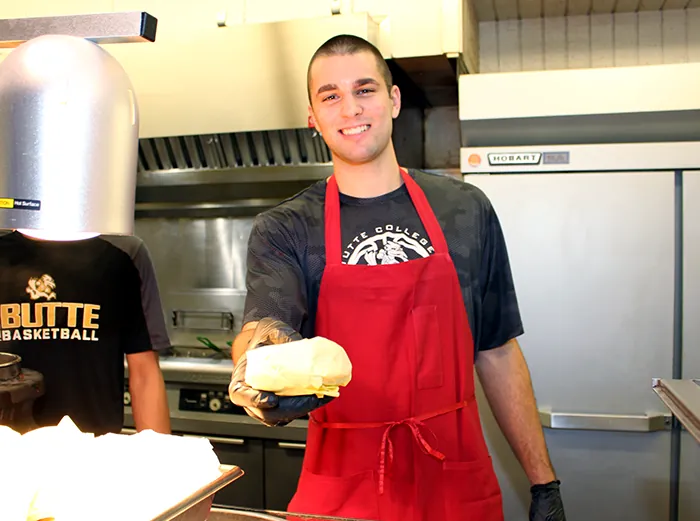 Butte College student serves meal at campus dining hall