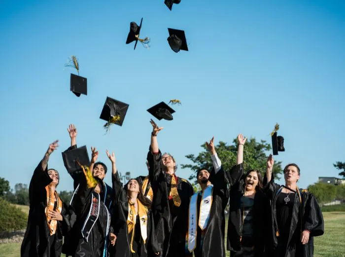 Butte College Students throw their graduation caps in the air
