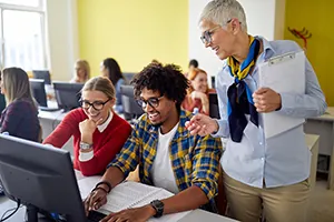 Butte College Faculty staff assist student in computer lab
