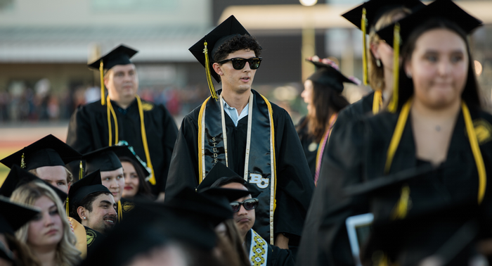 Butte College graduates walk towards the stage. 