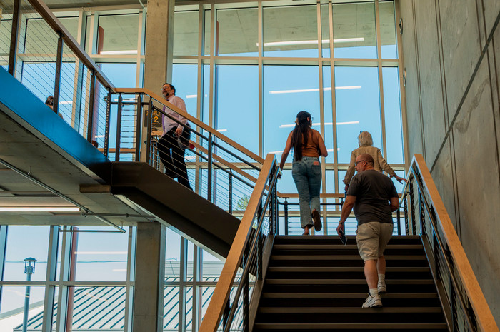 students-and-faculty-ascend-stairs-inside-science-building