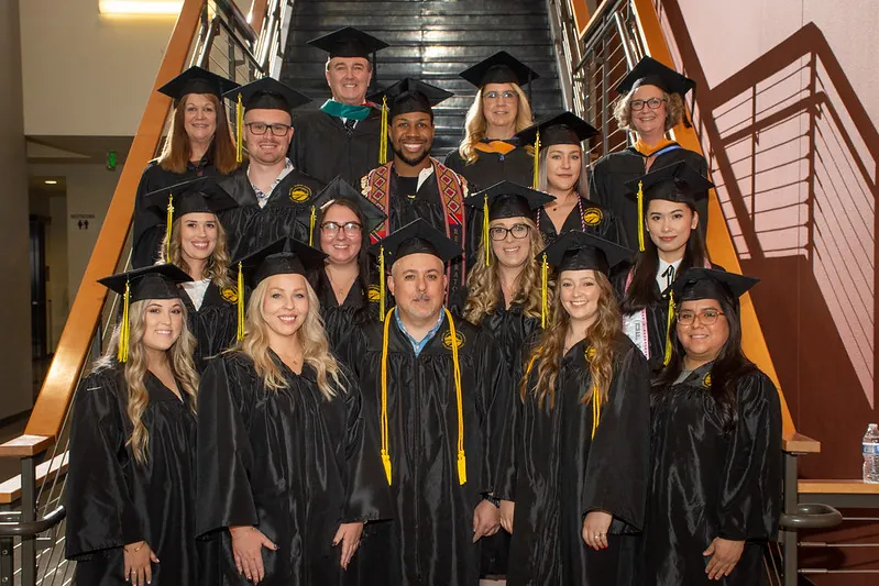 Butte College human resources graduates standing on stairs