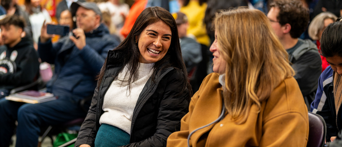 Two Butte employees attend an event on campus. 