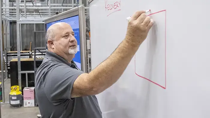 Butte College instructor writes on board in hvac program