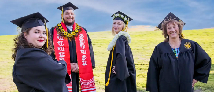 graduates-on-a-hill-with-their-professor
