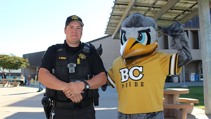 Butte College Officer Chavez and the school's mascot.