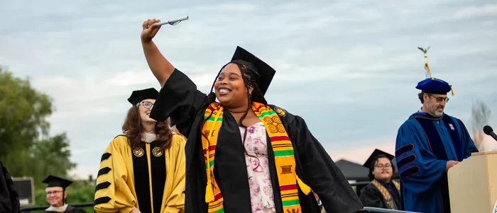 A Butte College graduate celebrates achieving her degree at commencement.