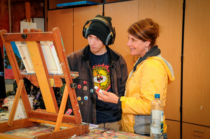 teacher admires students art