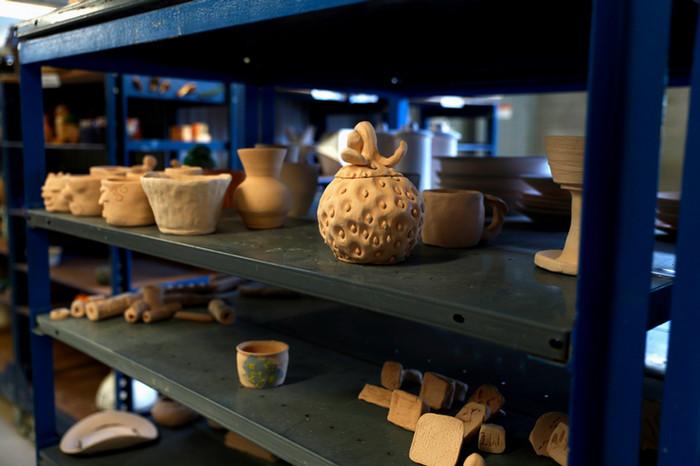 unglazed ceramic pieces on shelves
