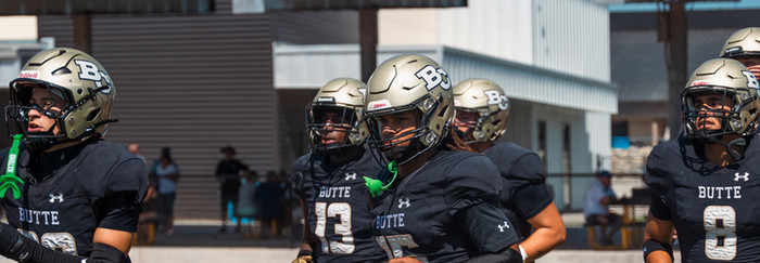 football players jogging onto feild