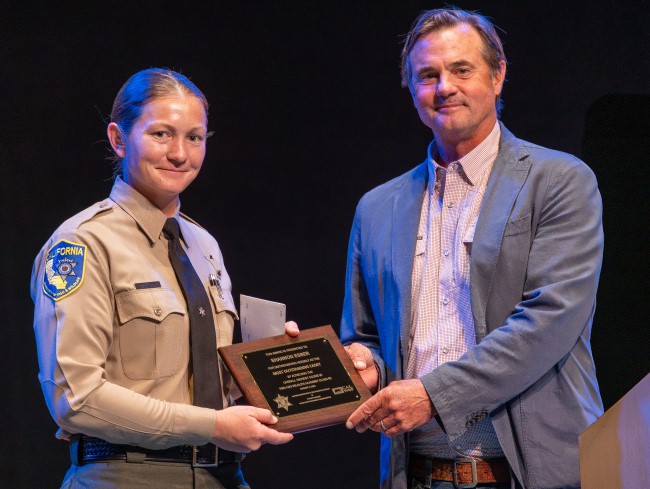fish and wildlife student graduates with award