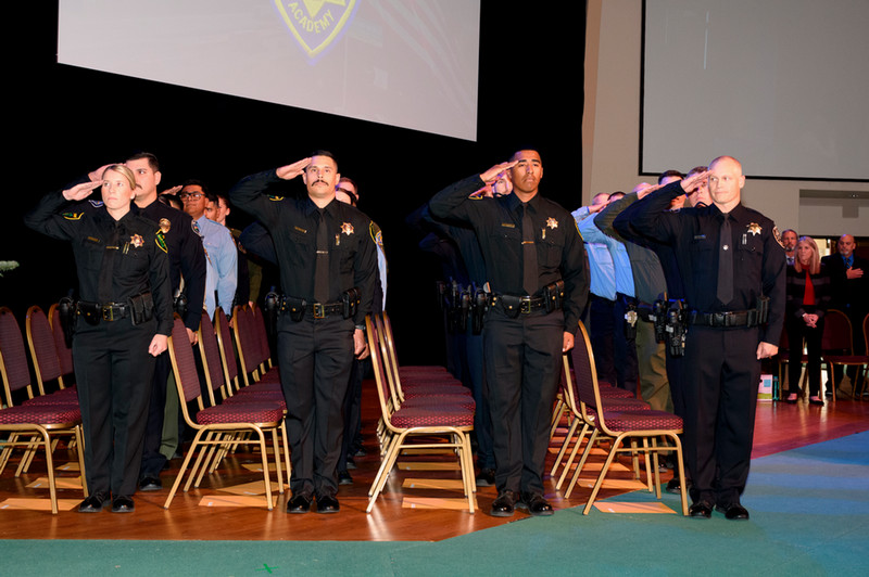 law enforcement cadets saluting at commencement