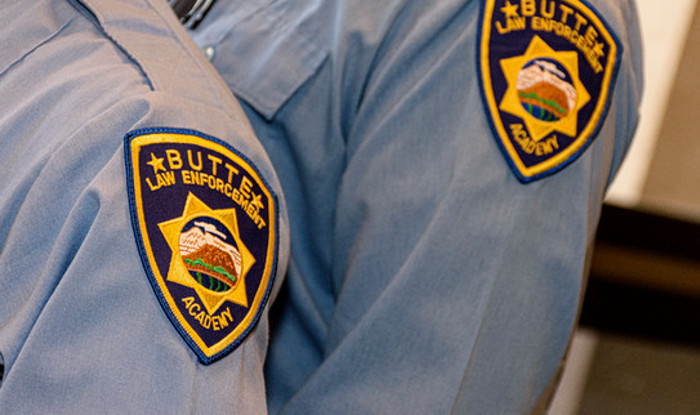 two shoulders with law enforcement academy patches