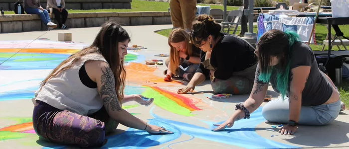 group-of-female-students-create-sidewalk-art