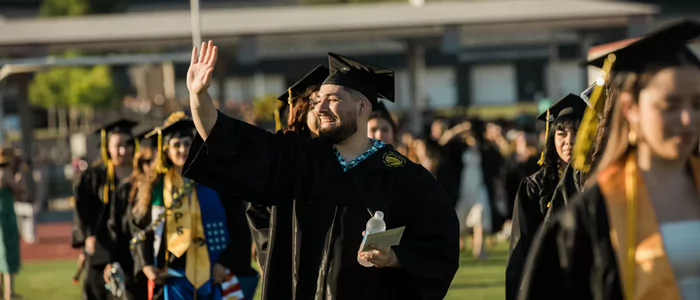 male-graduate-waving