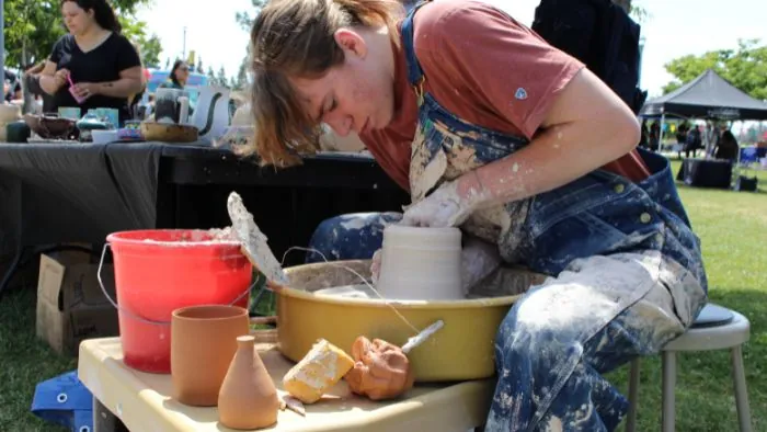 Butte College Student works pottery wheel at campus event