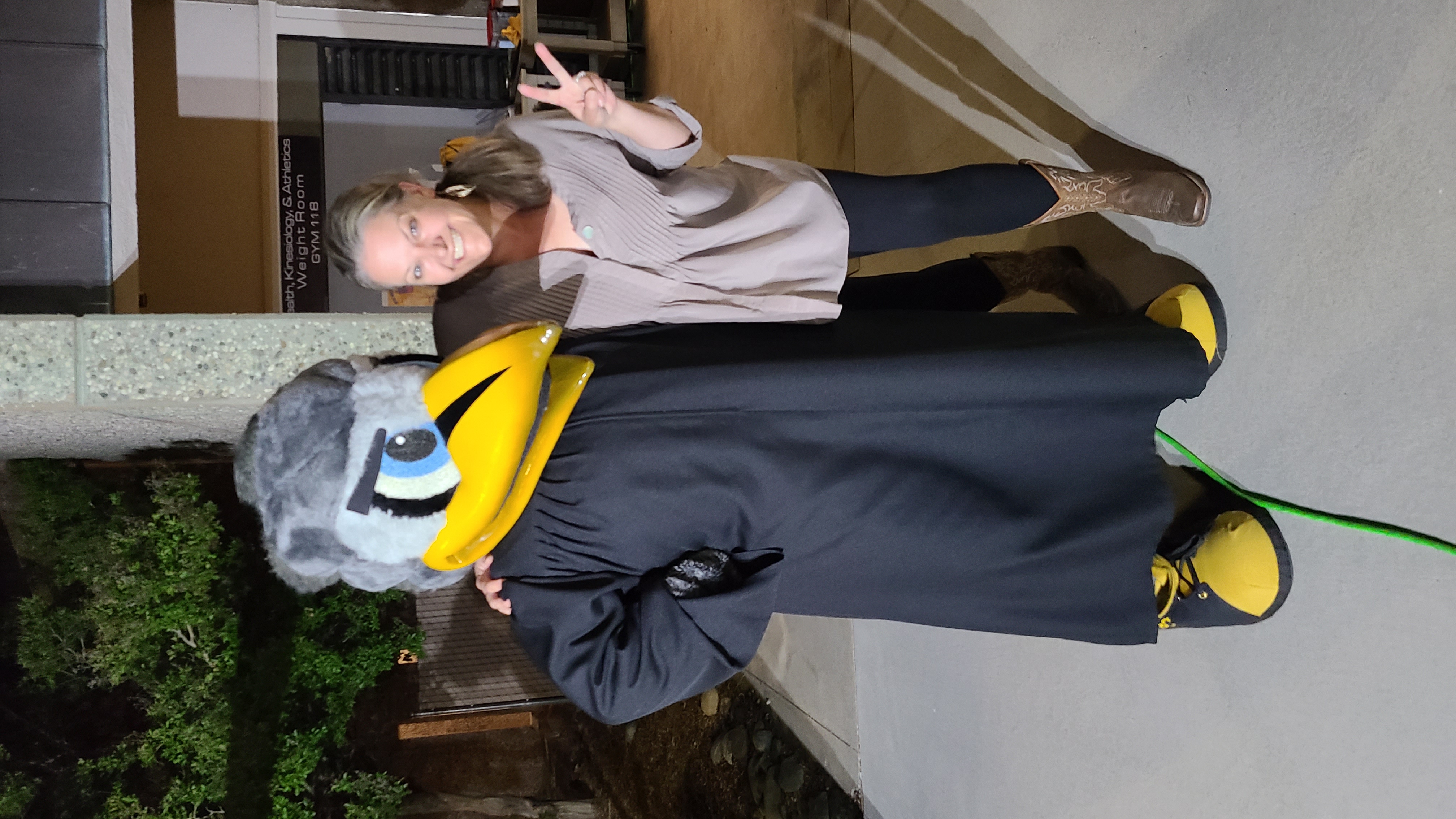 Carrie standing next to Dash the Mascot for Butte College