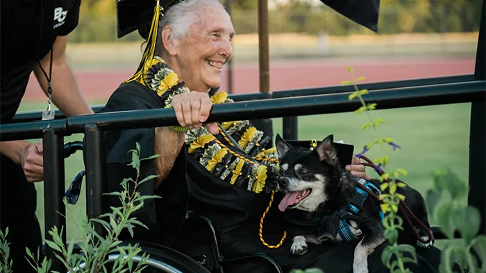Butte College Graduate in wheelchair celebrates at commencement ceremony