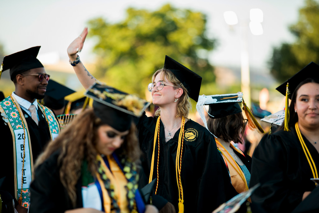 students-wave-to-crowd-at-commencement