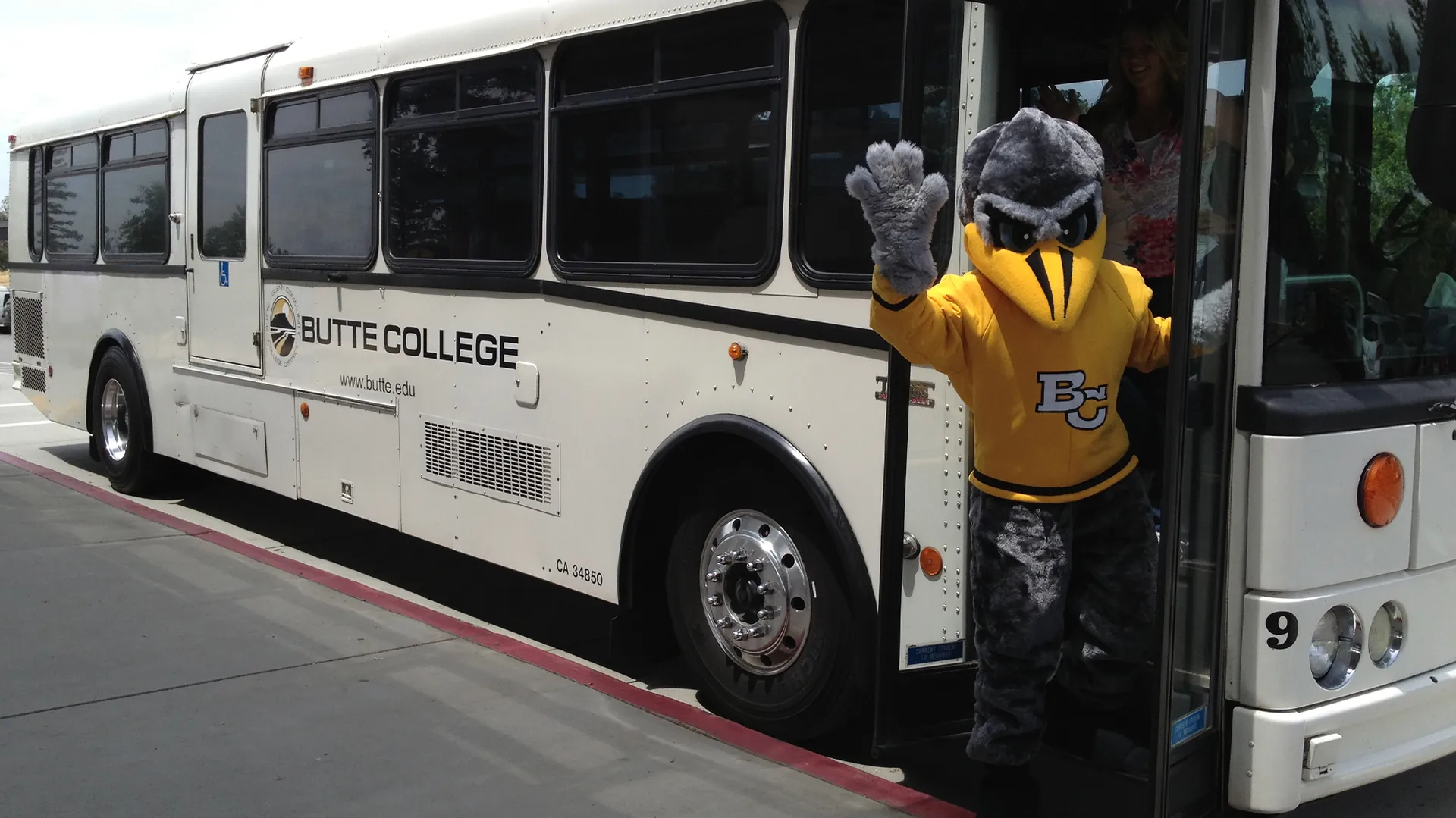 Dash Mascot waves as he boards the Butte College Bus