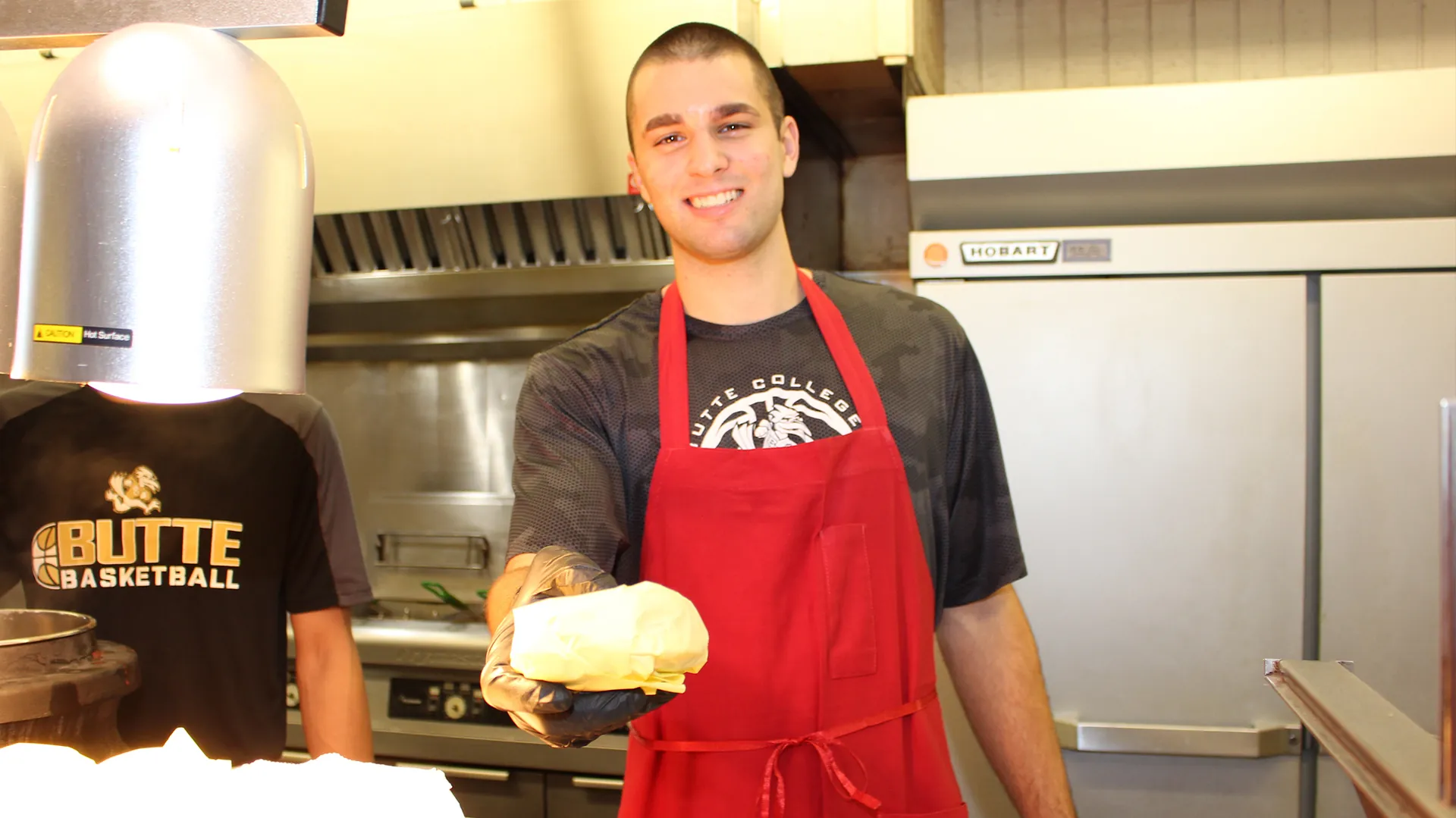 DIning Hall Student Staff Member serves meal