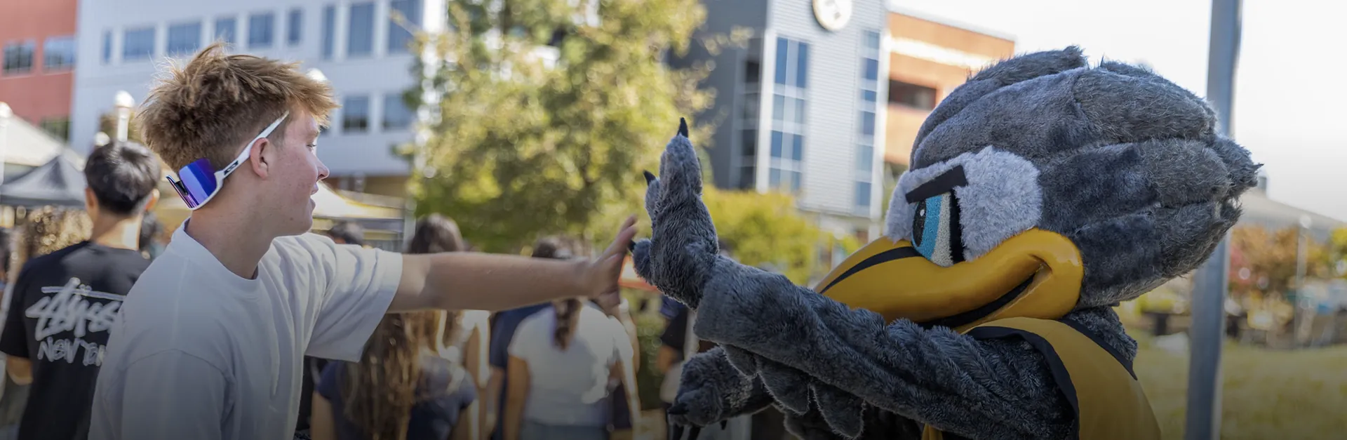 Butte College Student give Dash Mascot a high five