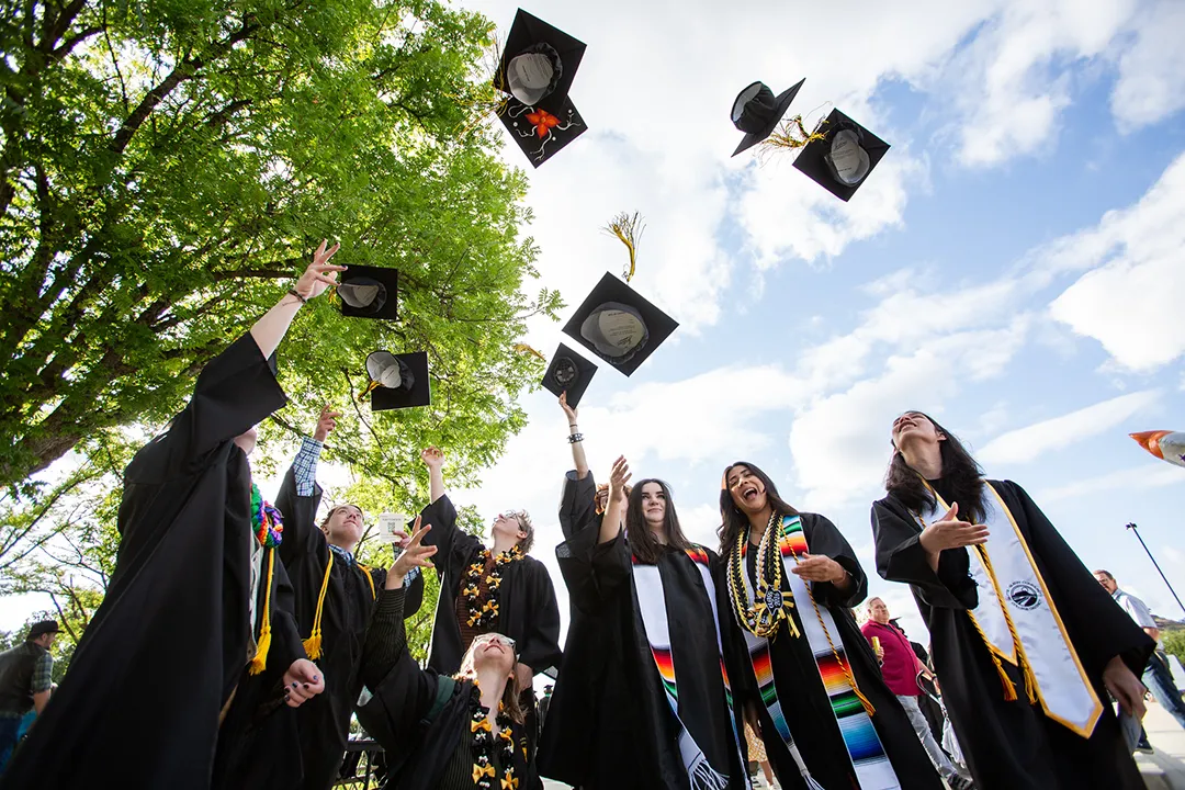 Butte College graduates toss their caps in the air.