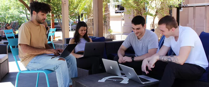 students-gather-for-online-learning-on-campus