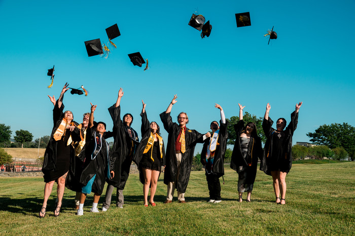 grads-jump-and-throw-caps-in-excitement